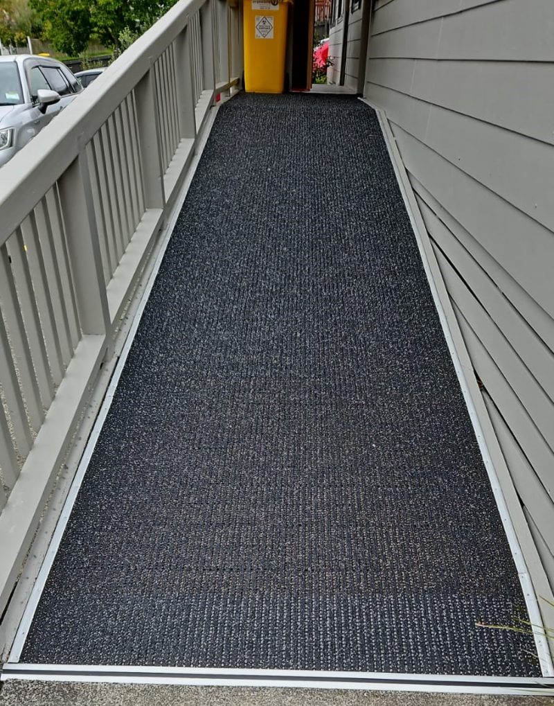Health Centre Ramp Four in One with carpet reducer bars at top and bottom and neat edge 365 on side framing.