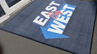 East West logo mat